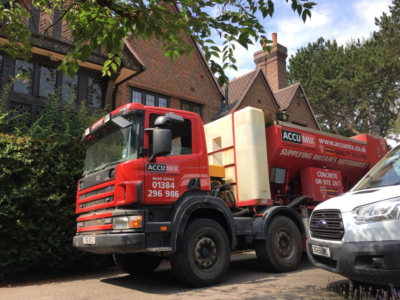 Truck delivering concrete to a domestic household